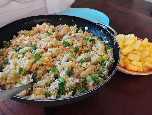 Close view of a skillet filled with a freshly cooked chicken fried rice recipe.